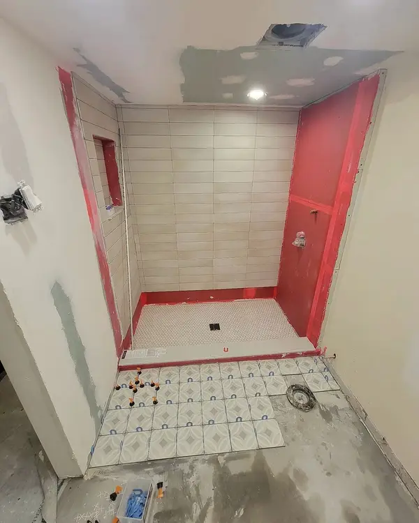 Stage 3: red waterproofing membrane on the shower walls and floor