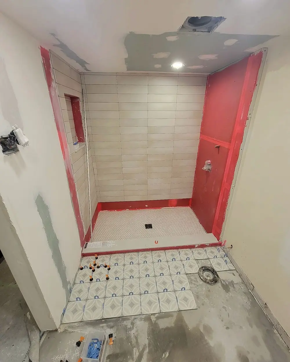 Stage 3: red waterproofing membrane on the shower walls and floor